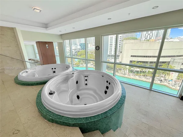 a bathroom with a tub and large window