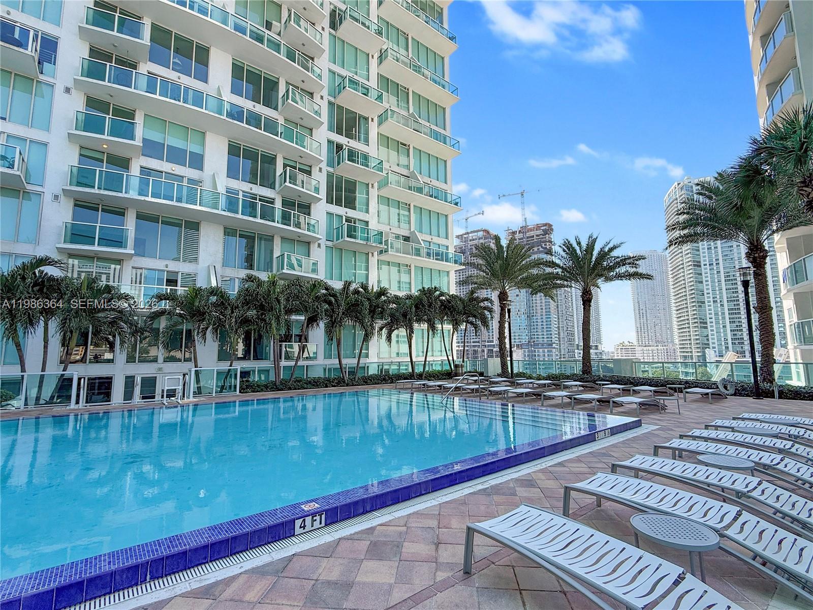 41 Southeast 5th Street, Unit 602 Miami, FL 33131 - Photo 41 of 43 a view of a swimming pool with outdoor seating