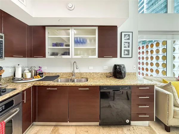 a kitchen with a sink window and cabinets