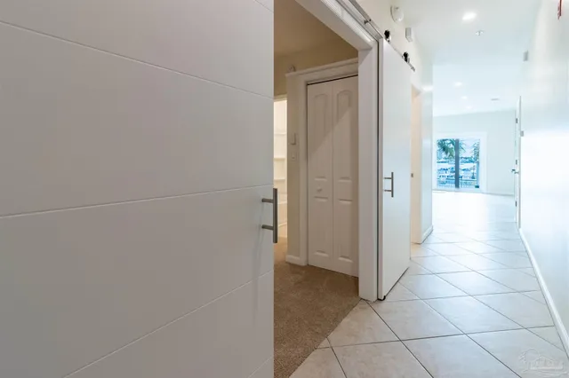 an empty room with entrance and windows