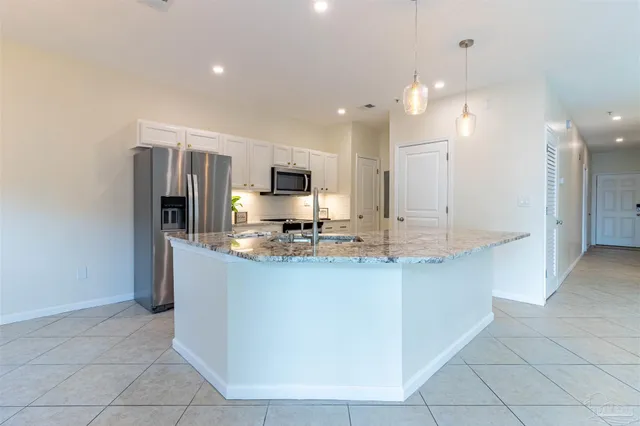 a kitchen with stainless steel appliances a sink and cabinets