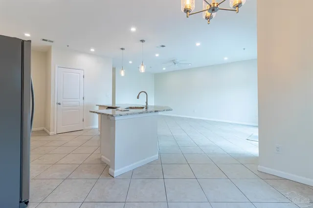 a kitchen with a stove a microwave and cabinets
