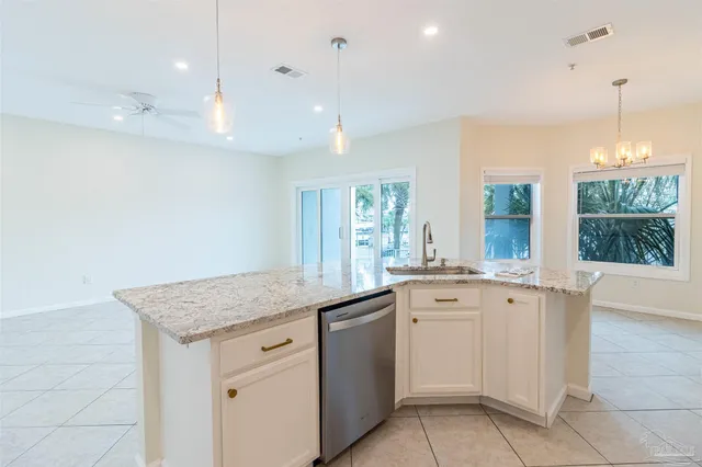a bedroom with a large bed and a potted plant