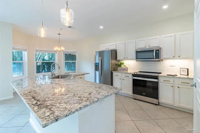 a living room with furniture flat screen tv and a large window