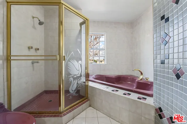 a bathroom with a tub shower and sink