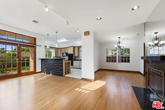 a kitchen with stainless steel appliances a refrigerator and wooden floor
