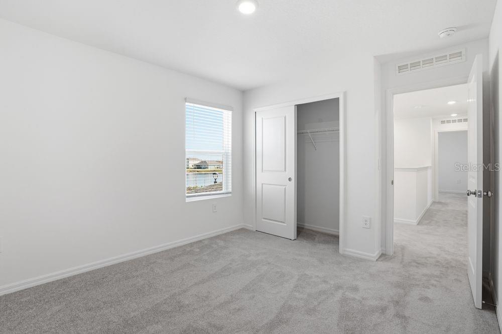 13243 Commons Avenue Parrish, FL 34219 - Photo 23 of 44 an empty room with windows and closet