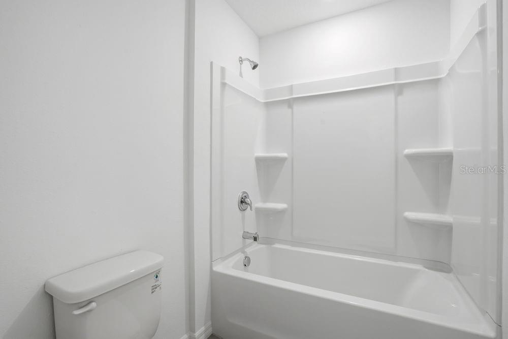 13243 Commons Avenue Parrish, FL 34219 - Photo 24 of 44 a bathroom with a bathtub and a toilet