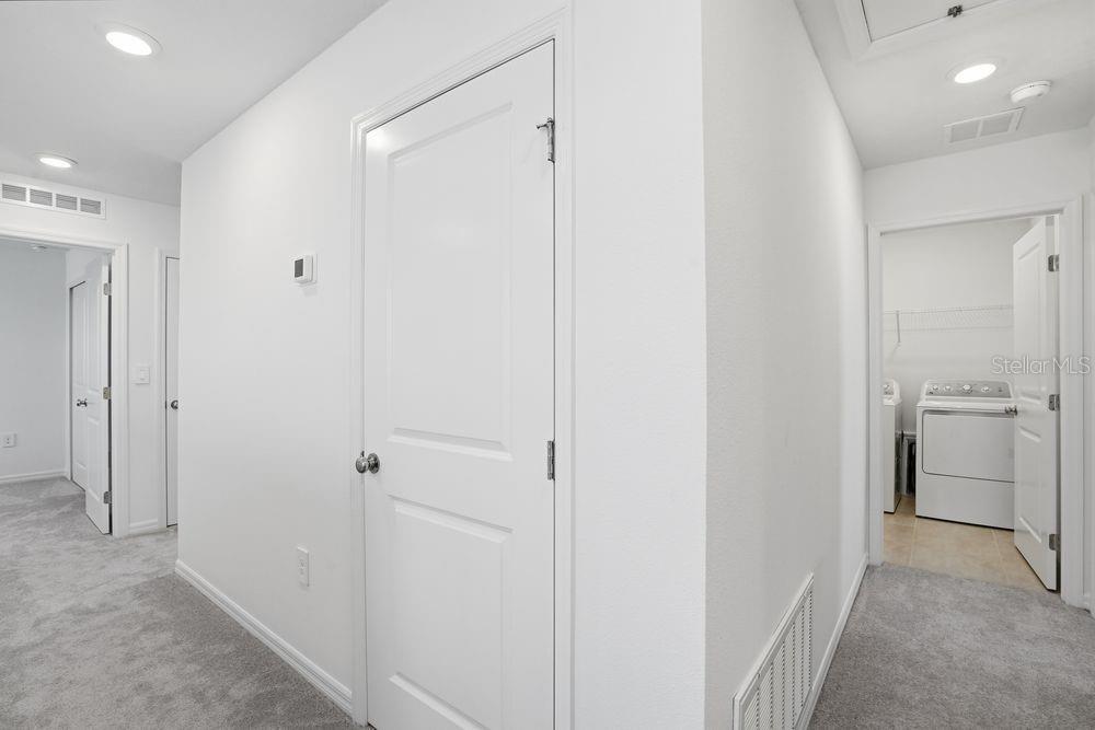 13243 Commons Avenue Parrish, FL 34219 - Photo 27 of 44 a view of a hallway with a refrigerator