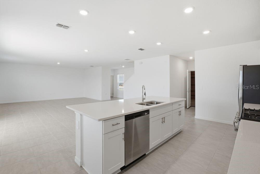 13243 Commons Avenue Parrish, FL 34219 - Photo 3 of 44 a kitchen with a sink stainless steel appliances and cabinets
