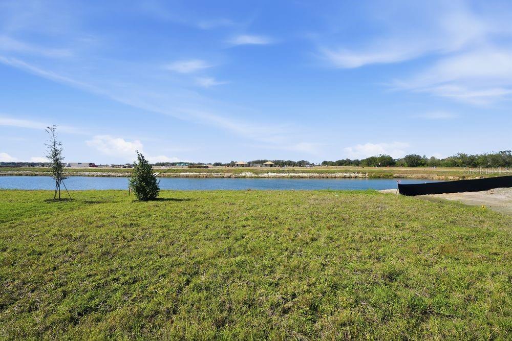13243 Commons Avenue Parrish, FL 34219 - Photo 33 of 44 a view of a lake with houses in the background