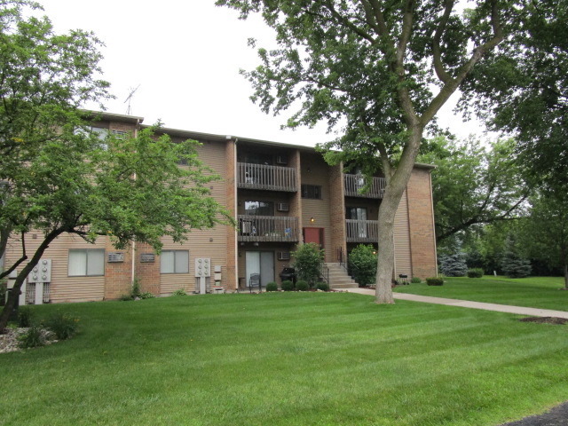 633 South Virginia Road, Unit 316 Crystal Lake, IL 60014 - Photo 14 of 14 a view of a wooden house with a big yard and large trees