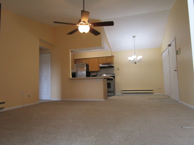 633 South Virginia Road, Unit 316 Crystal Lake, IL 60014 - Photo 6 of 14 a view of an empty room with a kitchen