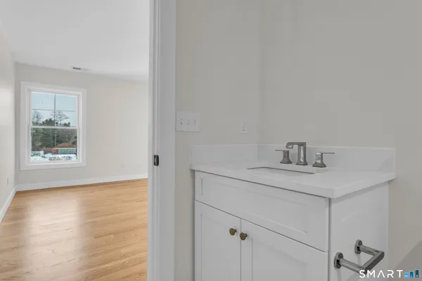 a kitchen with a sink cabinets and a window