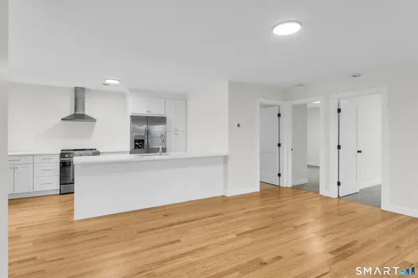 a view of kitchen with wooden floor and electronic appliances