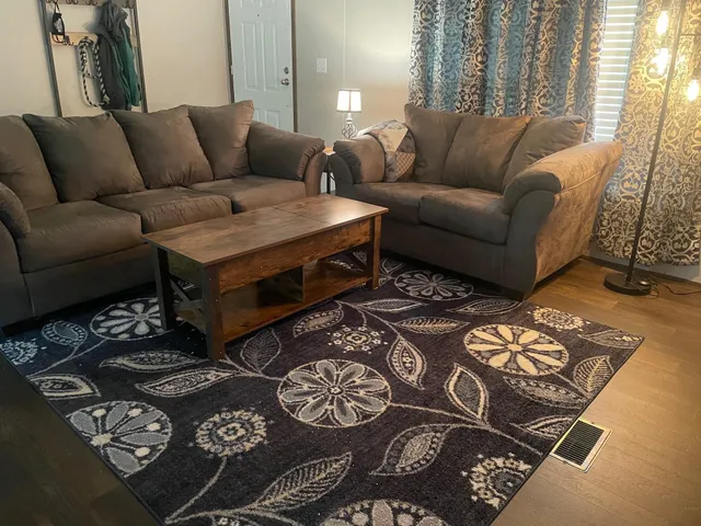 a dining room with furniture and wooden floor
