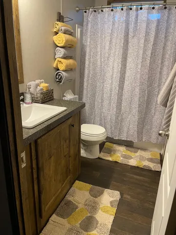 a bathroom with a toilet sink and mirror