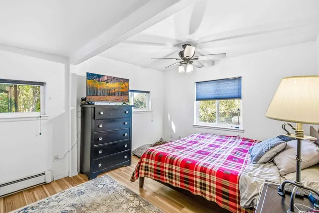 a bedroom with a bed and a tv on dresser