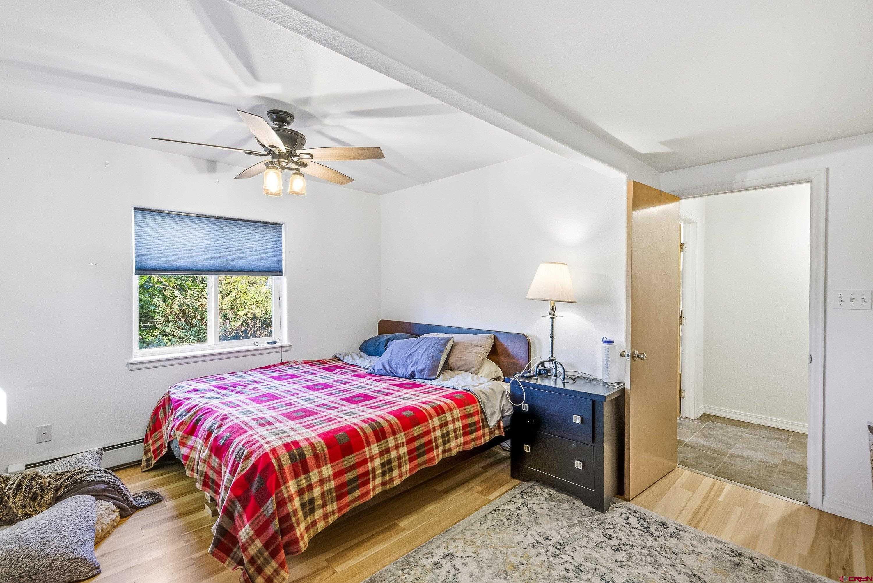 16459 Grange Road Paonia, CO 81428 - Photo 16 of 28 a bedroom with a bed and a window