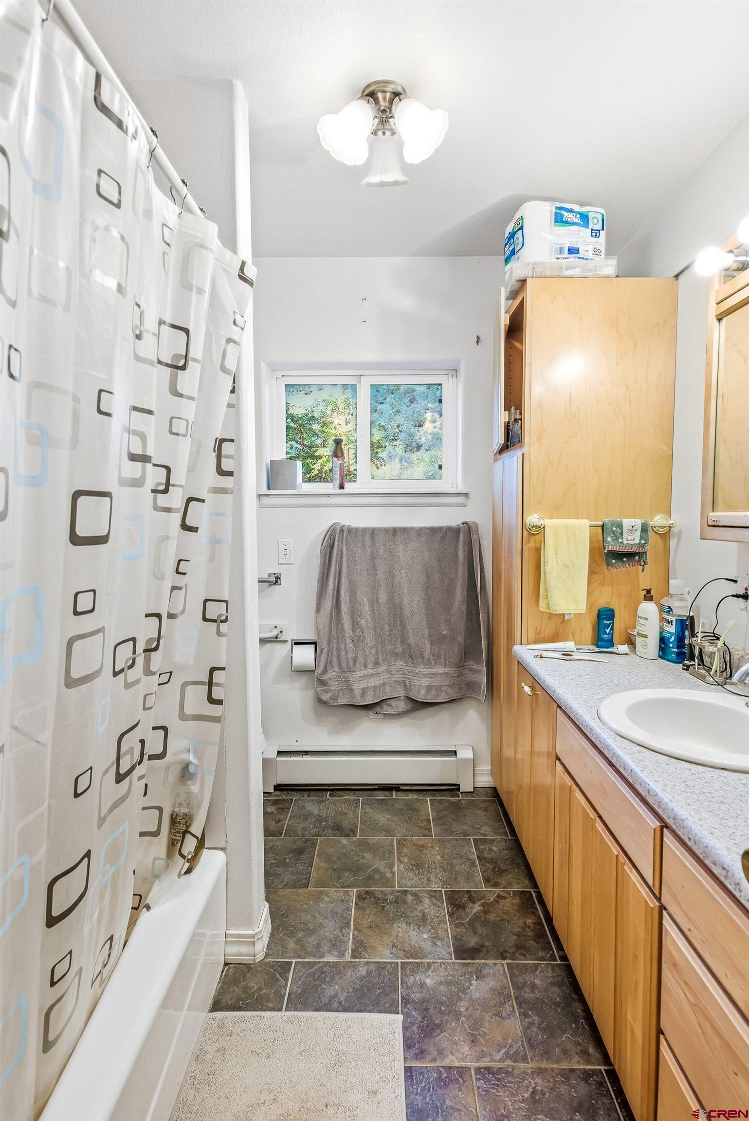 16459 Grange Road Paonia, CO 81428 - Photo 17 of 28 a bathroom with a tub sink and mirror