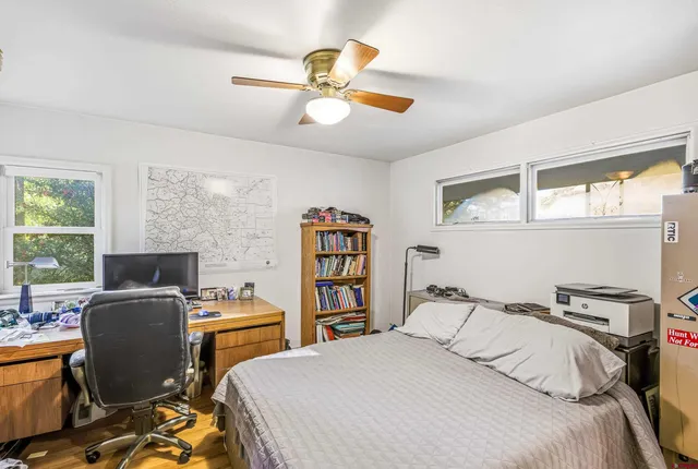 a bedroom with a bed and a desk