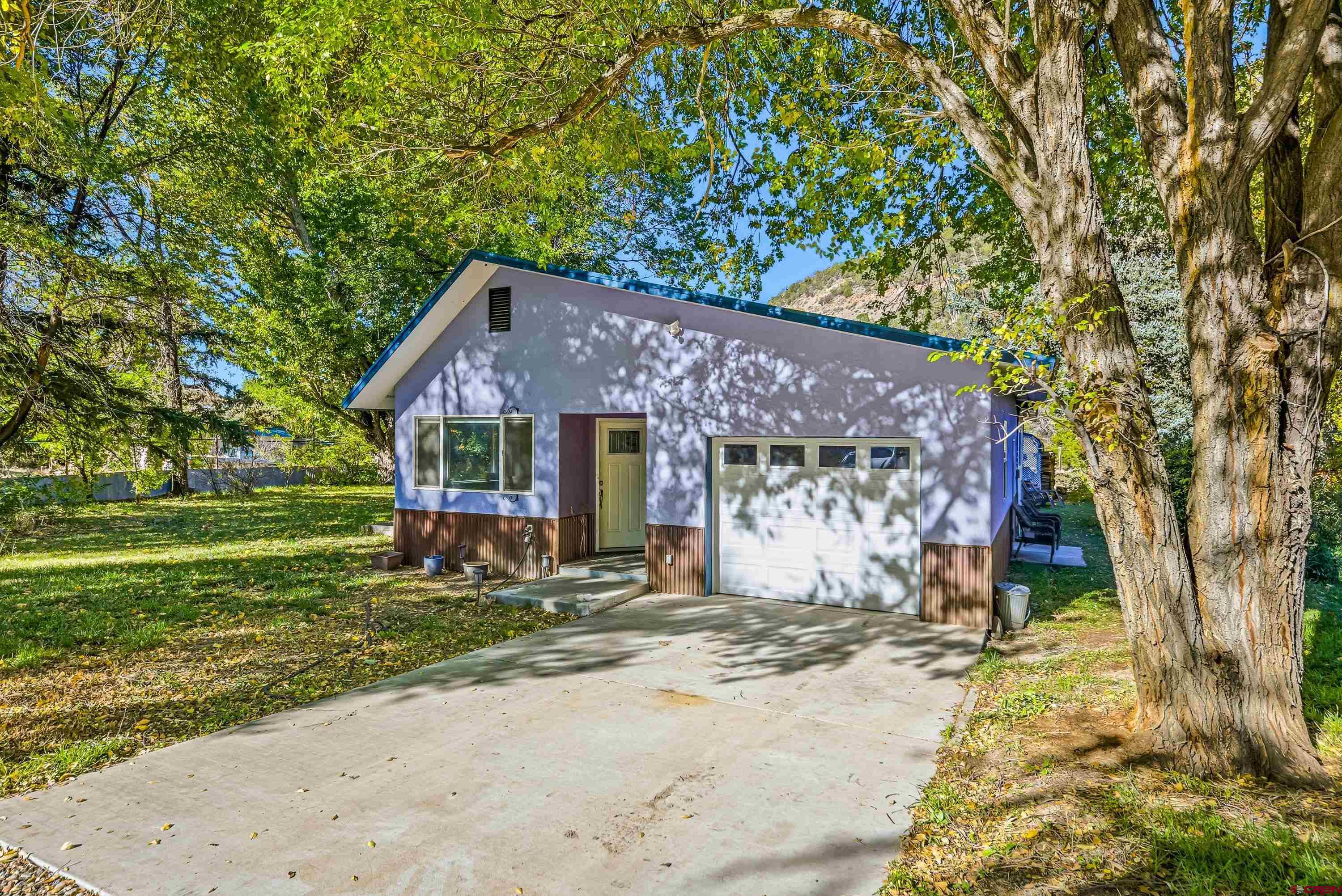 16459 Grange Road Paonia, CO 81428 - Photo 2 of 28 a front view of a house with a yard
