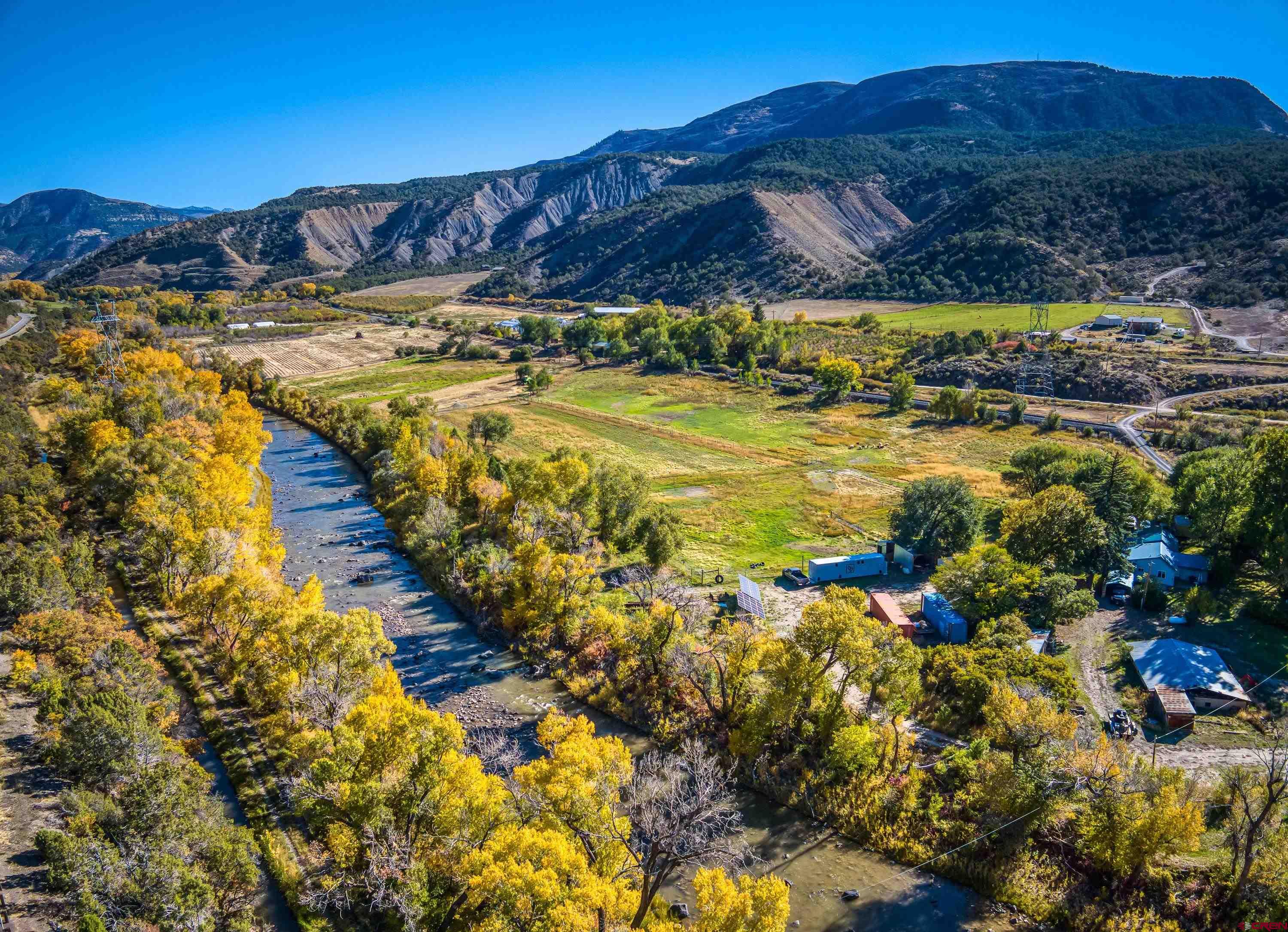 16459 Grange Road Paonia, CO 81428 - Photo 21 of 28 a view of an aerial view of residential houses with swimming pool and mountains