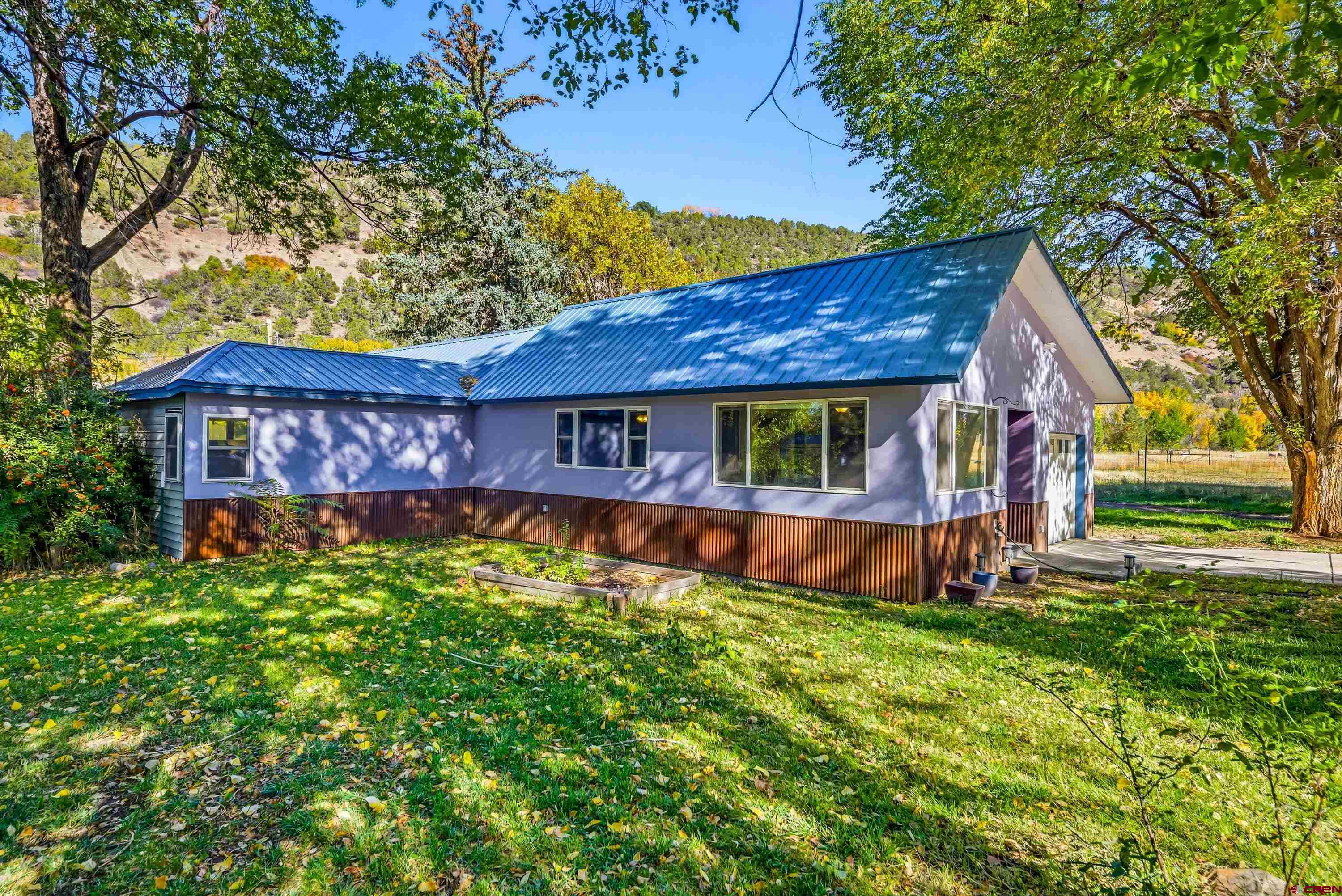 16459 Grange Road Paonia, CO 81428 - Photo 3 of 28 a view of a house with a yard
