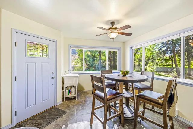 a view of a dining room with furniture window and outside view