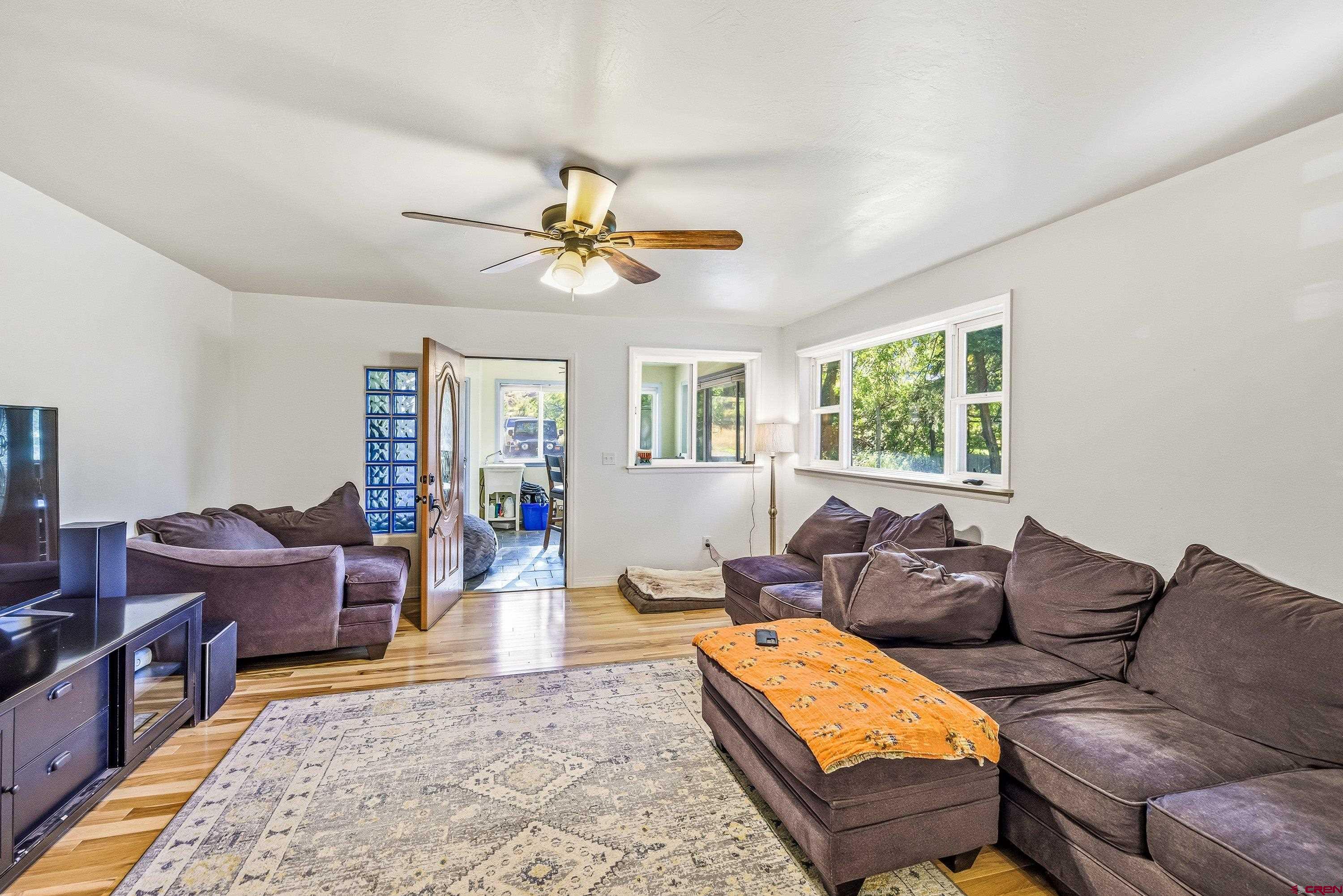 16459 Grange Road Paonia, CO 81428 - Photo 7 of 28 a living room with furniture ceiling fan and a window