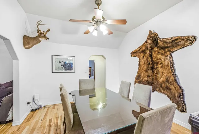 a view of a dining room with furniture and wooden floor