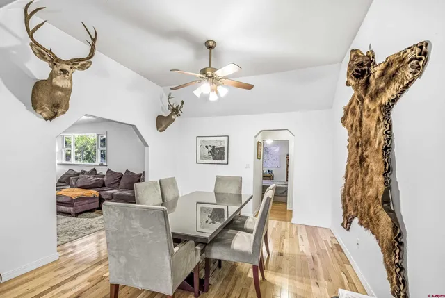 a view of a dining room with furniture and chandelier