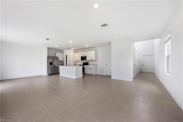a view of a kitchen with a sink and a refrigerator