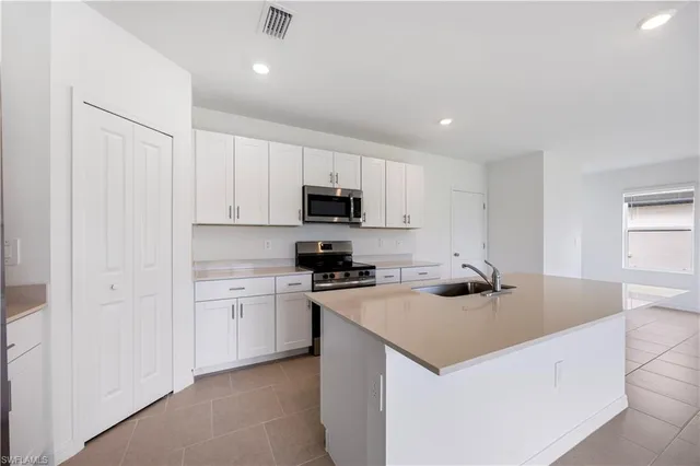a kitchen that has a sink and a stove in it