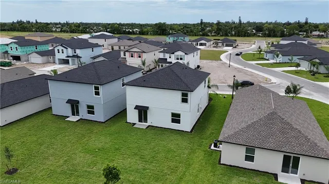 an aerial view of a house with garden space and lake view