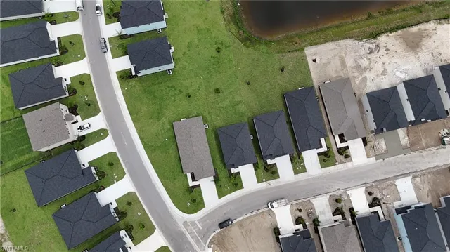 an aerial view of residential houses with outdoor space and pool