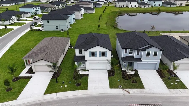 an aerial view of a house with a garden and trees