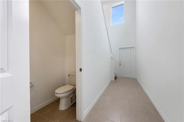 a bathroom with a granite countertop toilet and a sink