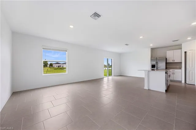 a view of kitchen with furniture and a refrigerator