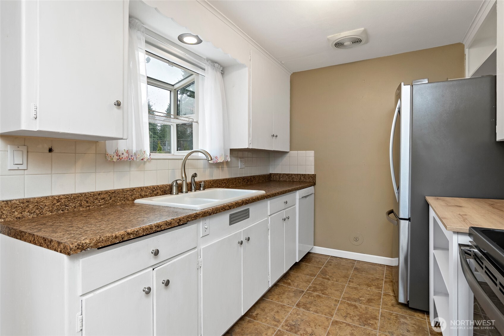 527 Ramsdell Street Fircrest, WA 98466 - Photo 14 of 40 a kitchen with stainless steel appliances granite countertop a sink stove and refrigerator
