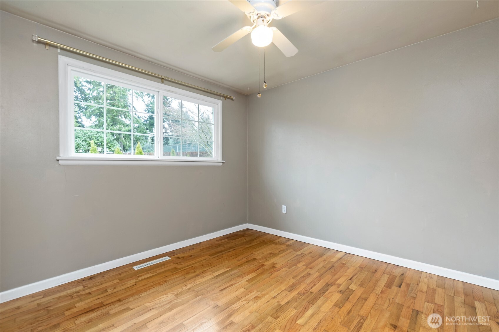 527 Ramsdell Street Fircrest, WA 98466 - Photo 16 of 40 a view of empty room with wooden floor and fan