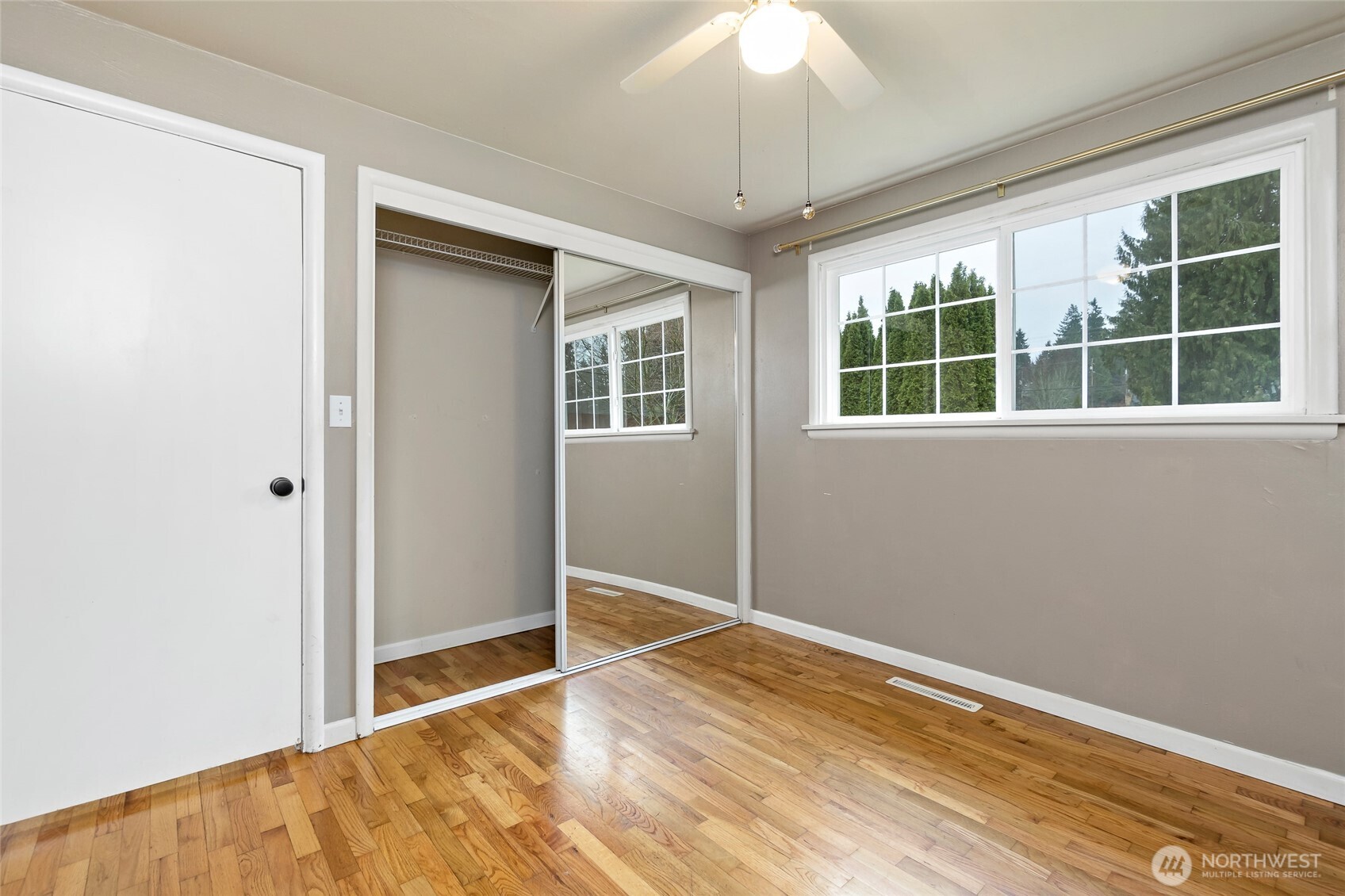 527 Ramsdell Street Fircrest, WA 98466 - Photo 18 of 40 an empty room with wooden floor and windows