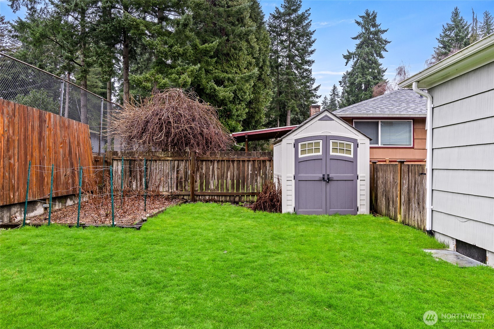 527 Ramsdell Street Fircrest, WA 98466 - Photo 30 of 40 a view of a wooden house with a small yard and wooden fence
