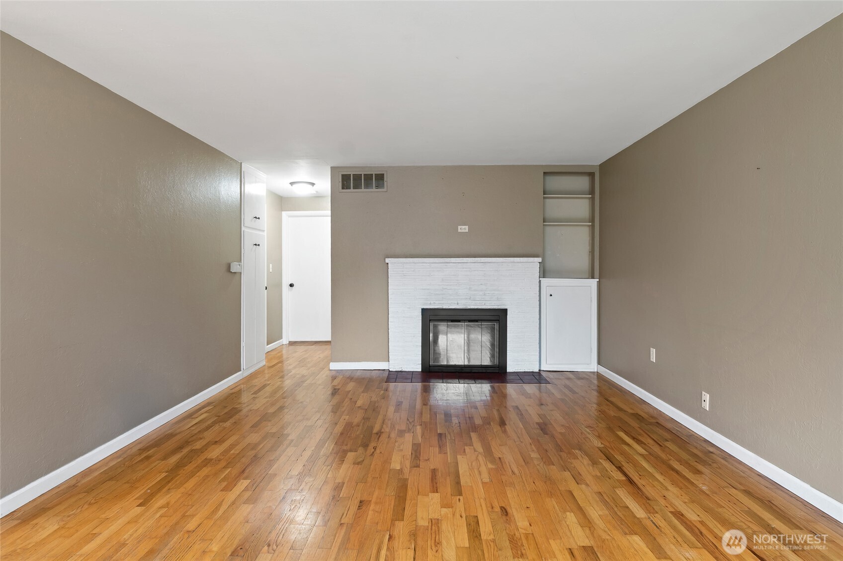 527 Ramsdell Street Fircrest, WA 98466 - Photo 6 of 40 a view of empty room with wooden floor and fireplace