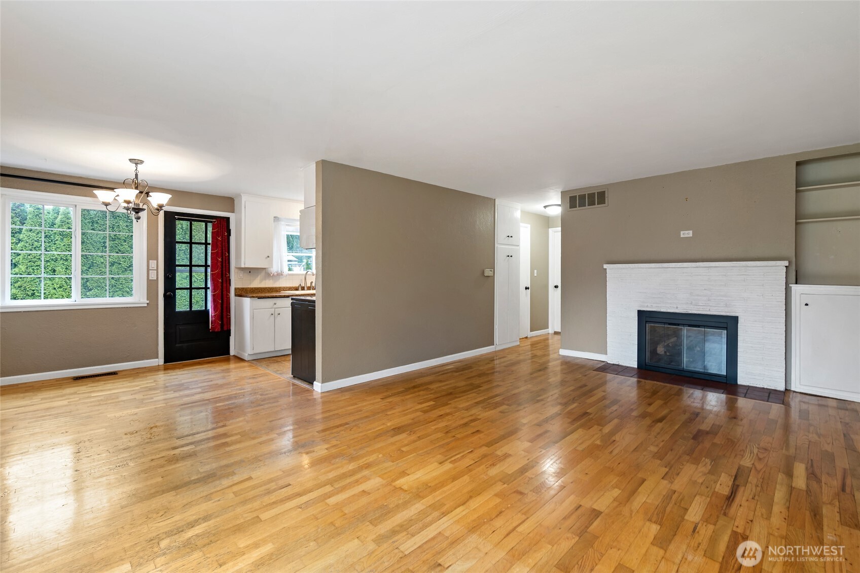 527 Ramsdell Street Fircrest, WA 98466 - Photo 7 of 40 a view of empty room with wooden floor and fireplace