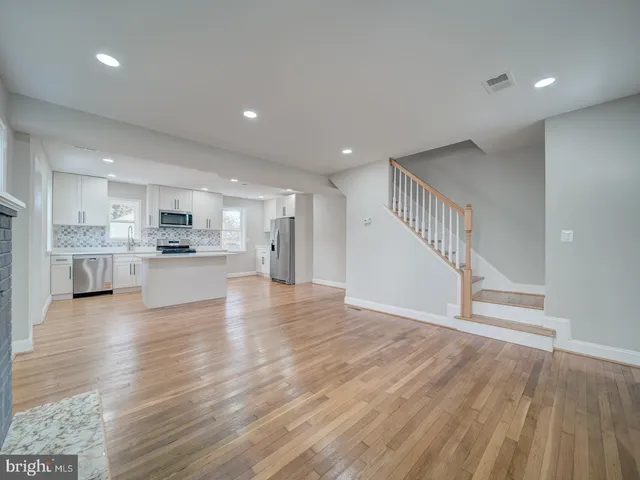 a view of kitchen with wooden floor and windows