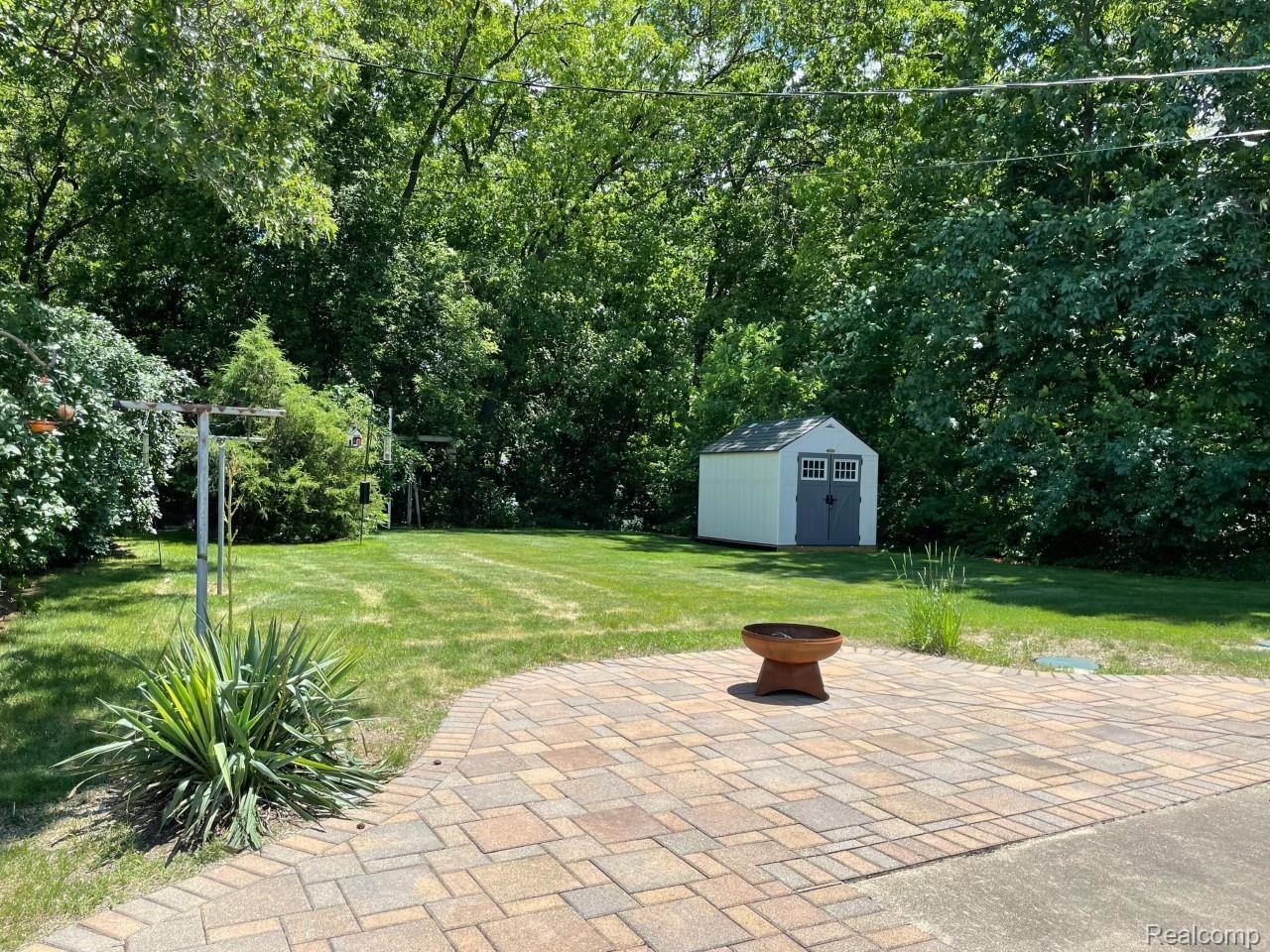 5099 Culver Road Brighton, MI 48114 - Photo 13 of 14 Large paver patio overlooks treed backyard.