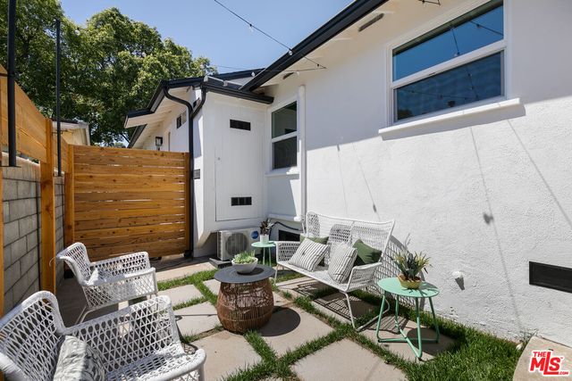 a view of backyard of house with seating space