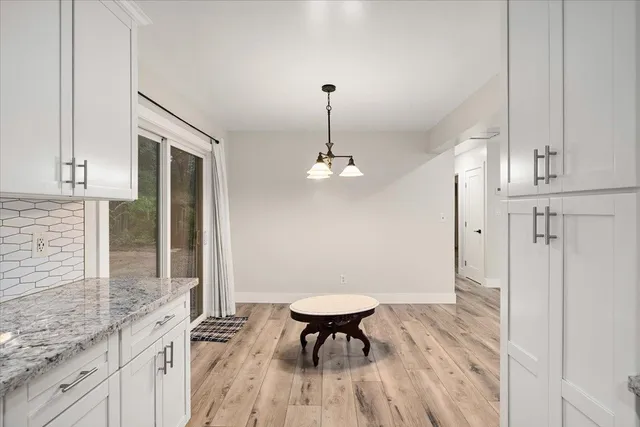 a view of a kitchen with a table and chairs