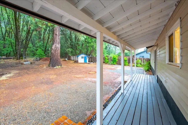 a view of a room with wooden floor and iron stairs